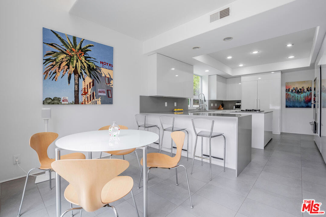 24050 Park Casino Calabasas, CA 91302 - Photo 17 of 43 a dining room with stainless steel appliances kitchen island granite countertop a dining table chairs and a refrigerator