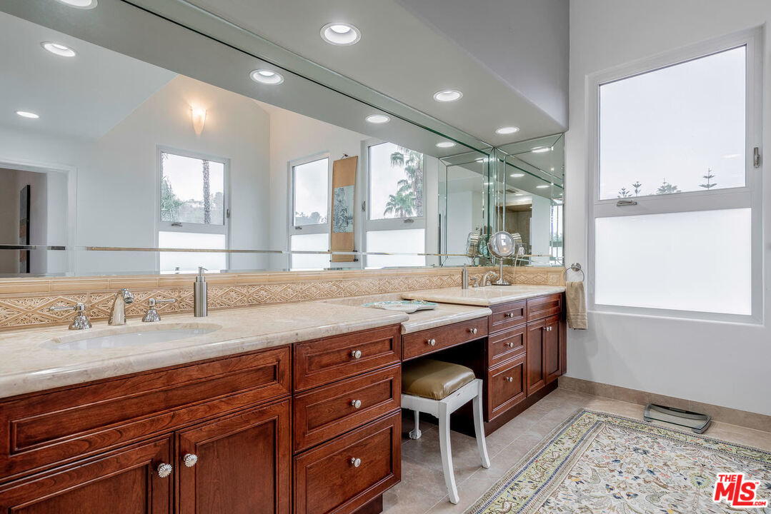24050 Park Casino Calabasas, CA 91302 - Photo 31 of 43 a bathroom with a granite countertop sink and a mirror