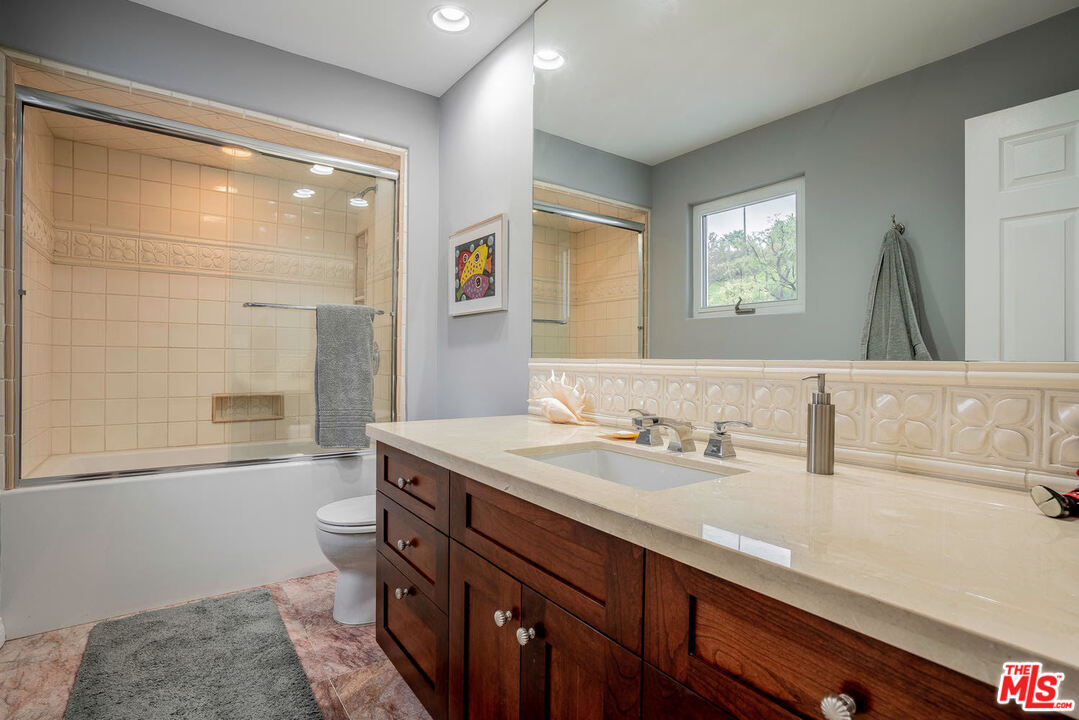 24050 Park Casino Calabasas, CA 91302 - Photo 34 of 43 a bathroom with a granite countertop sink a mirror and a shower