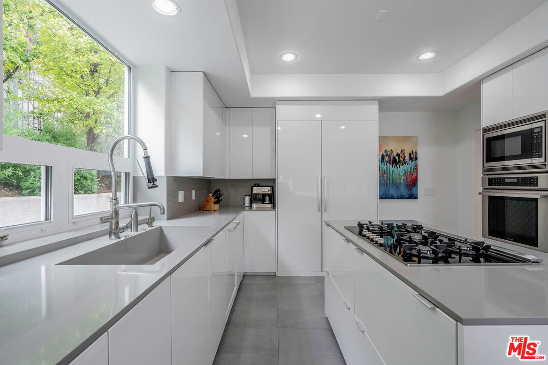 24050 Park Casino Calabasas, CA 91302 - Photo 5 of 43 a kitchen with sink a stove and white cabinets