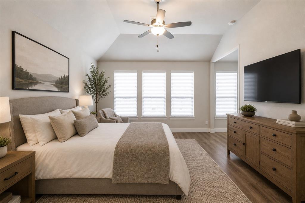 2901 Quinton Street Prosper, TX 75078 - Photo 13 of 27 a bedroom with a large bed and a flat screen tv