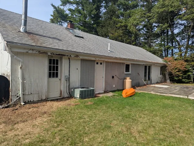 a front view of a house with yard and porch