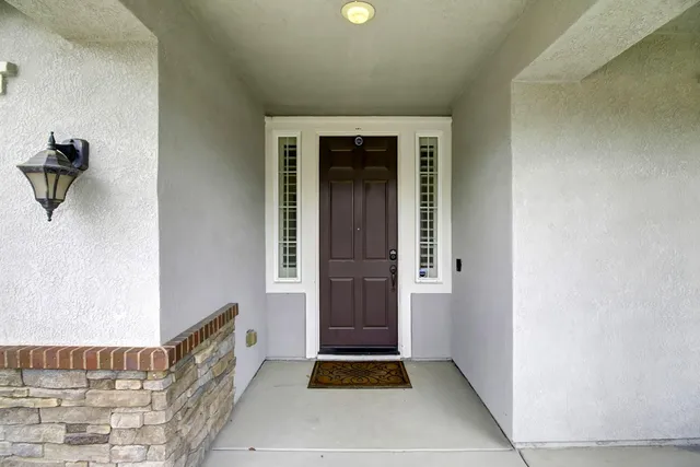a view of a dining room with furniture and chandelier