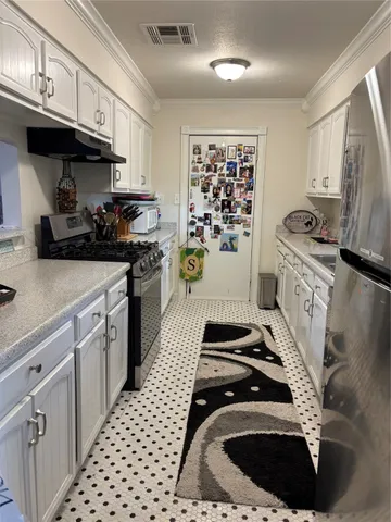a kitchen with a stove a sink and a refrigerator