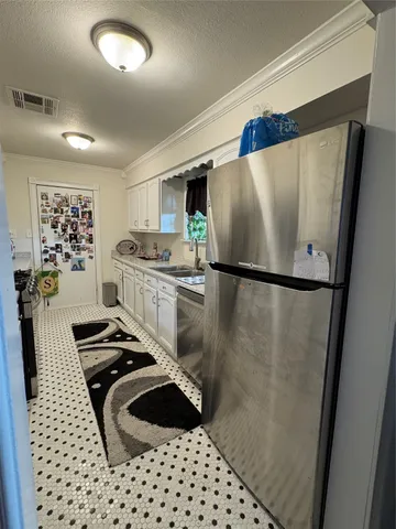 a kitchen with a refrigerator and a stove