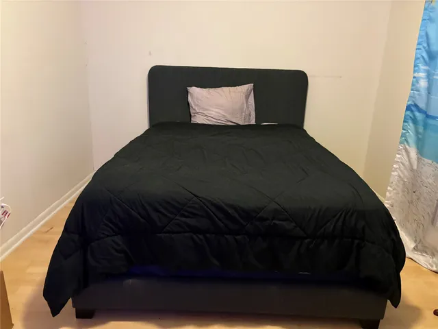 a black car sitting on a bed in a bedroom