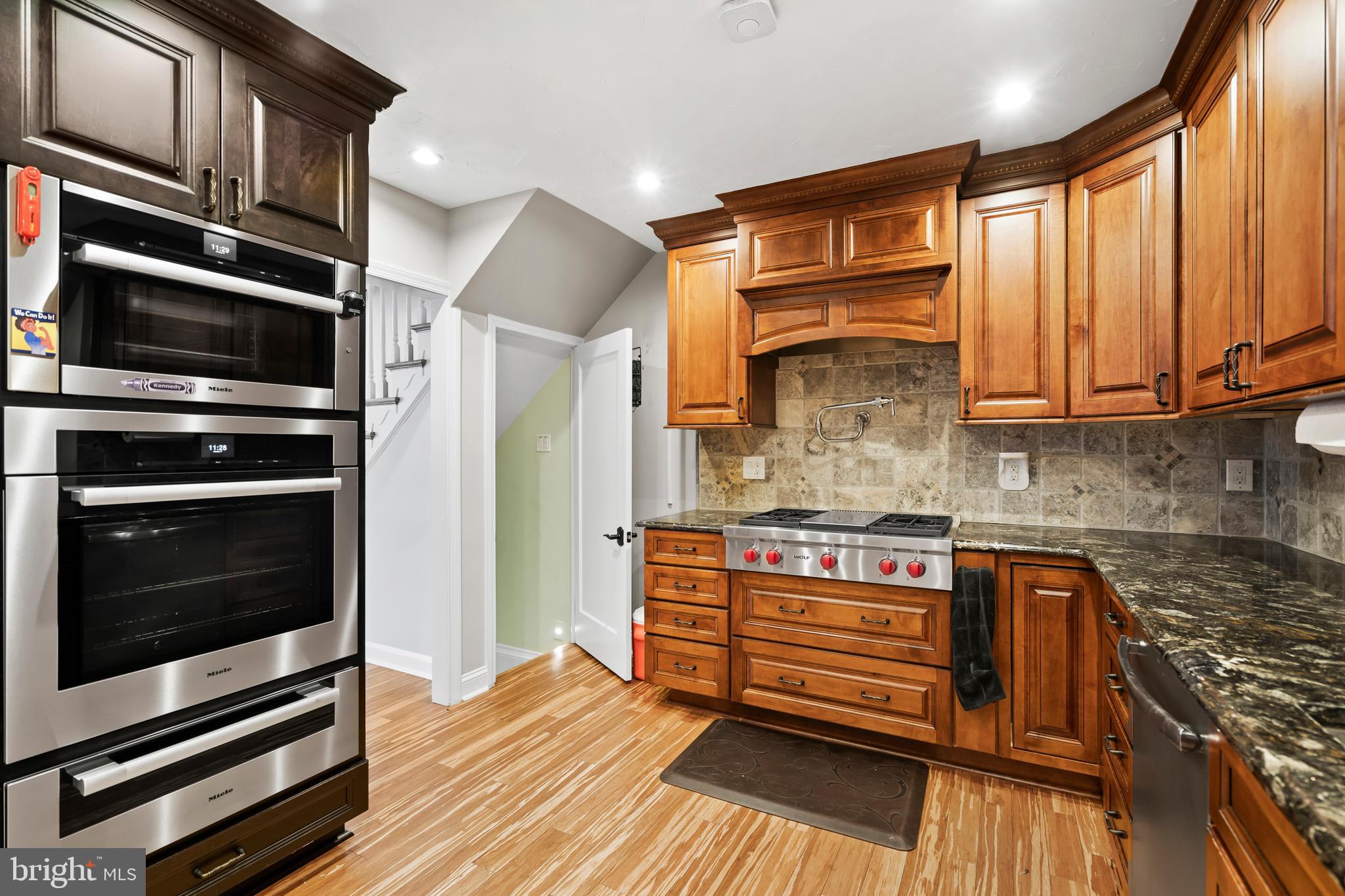 1028 Foss Avenue Drexel Hill, PA 19026 - Photo 11 of 48 a kitchen with stainless steel appliances granite countertop a stove and cabinets