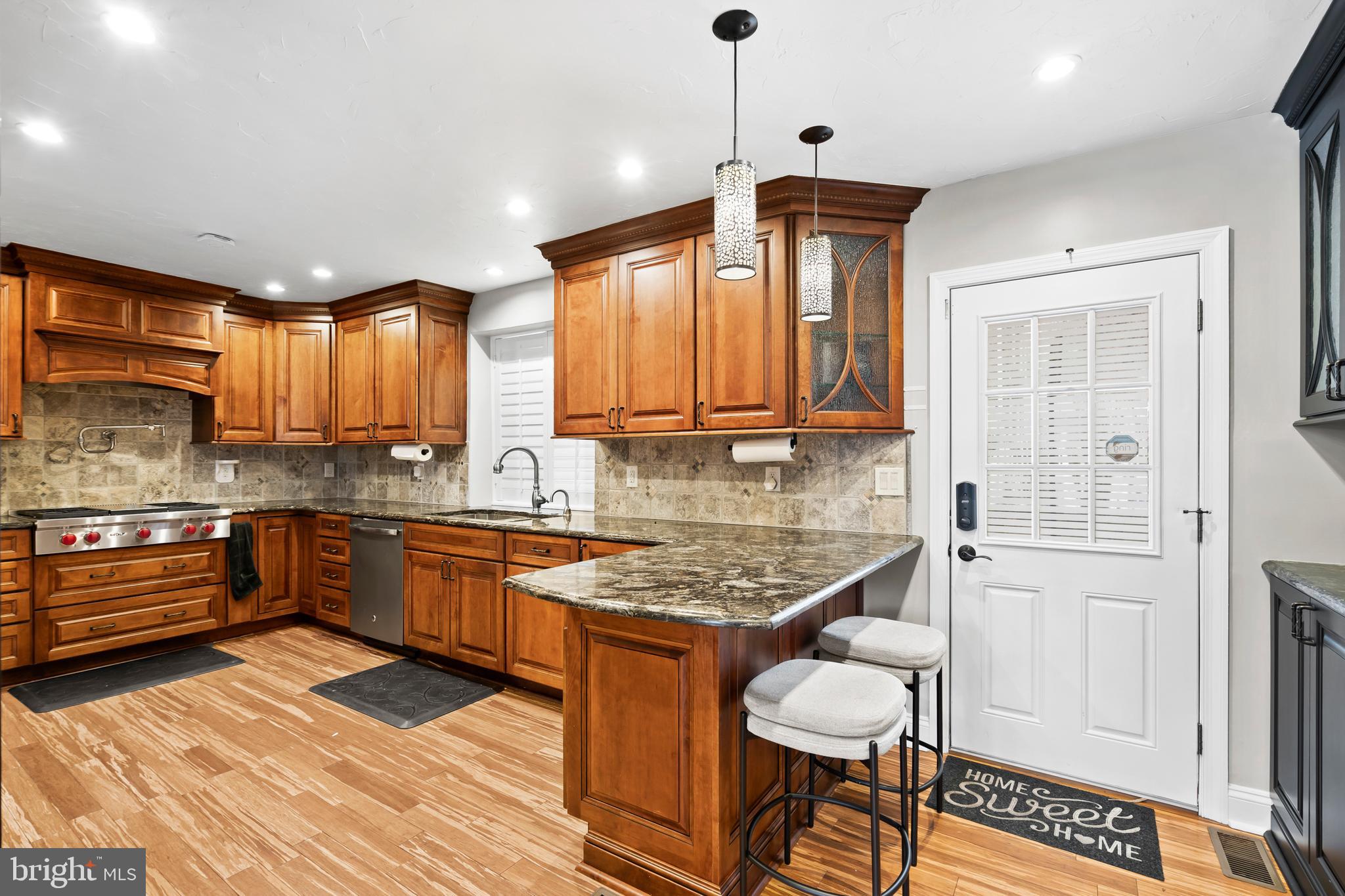1028 Foss Avenue Drexel Hill, PA 19026 - Photo 14 of 48 a kitchen with granite countertop a stove cabinets and wooden floor