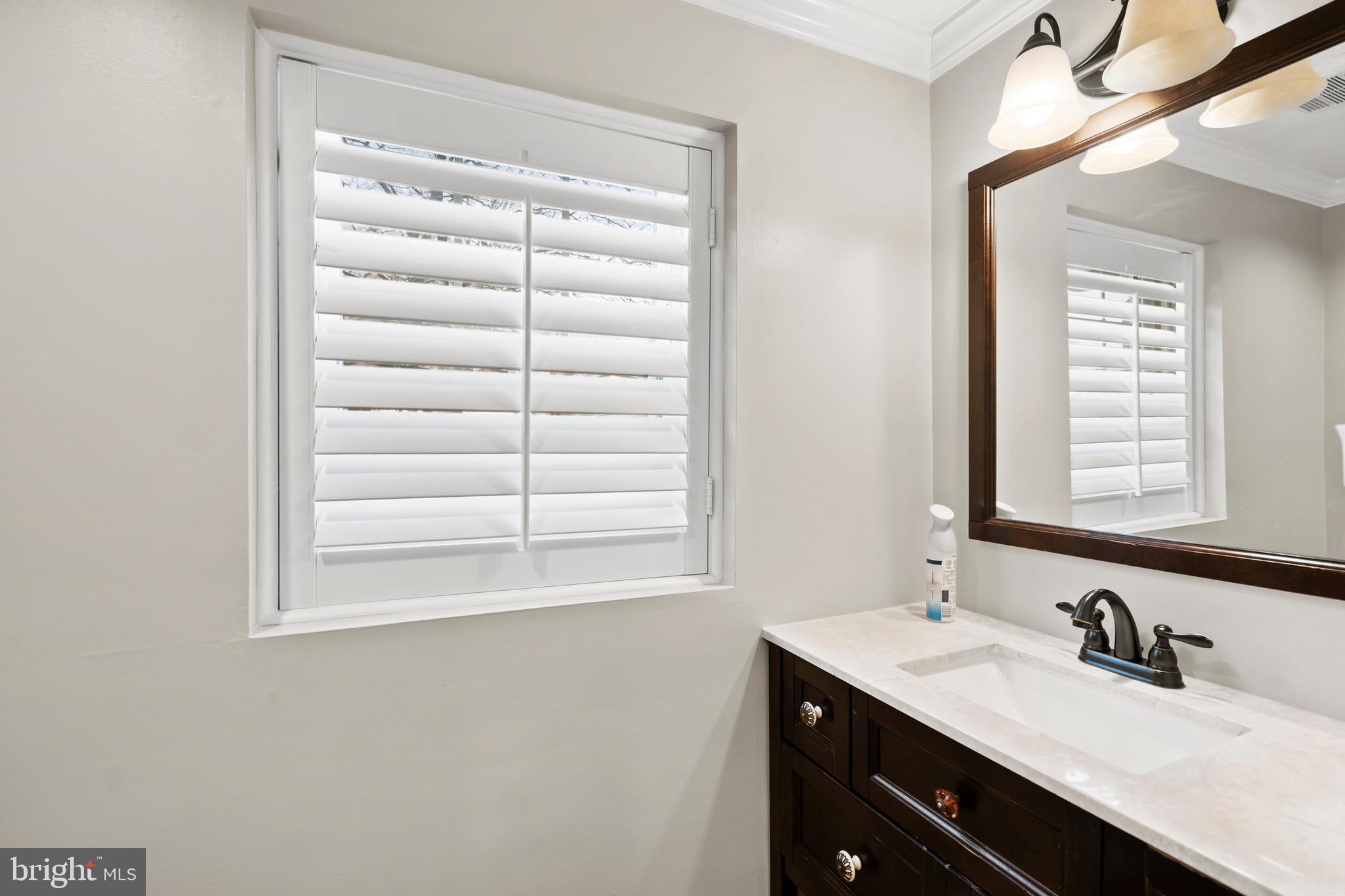 1028 Foss Avenue Drexel Hill, PA 19026 - Photo 18 of 48 a bathroom with a double vanity sink and a window