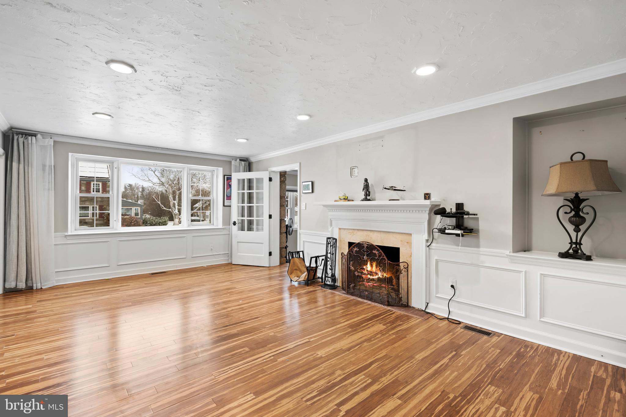 1028 Foss Avenue Drexel Hill, PA 19026 - Photo 6 of 48 wooden floor fireplace and windows in an empty room