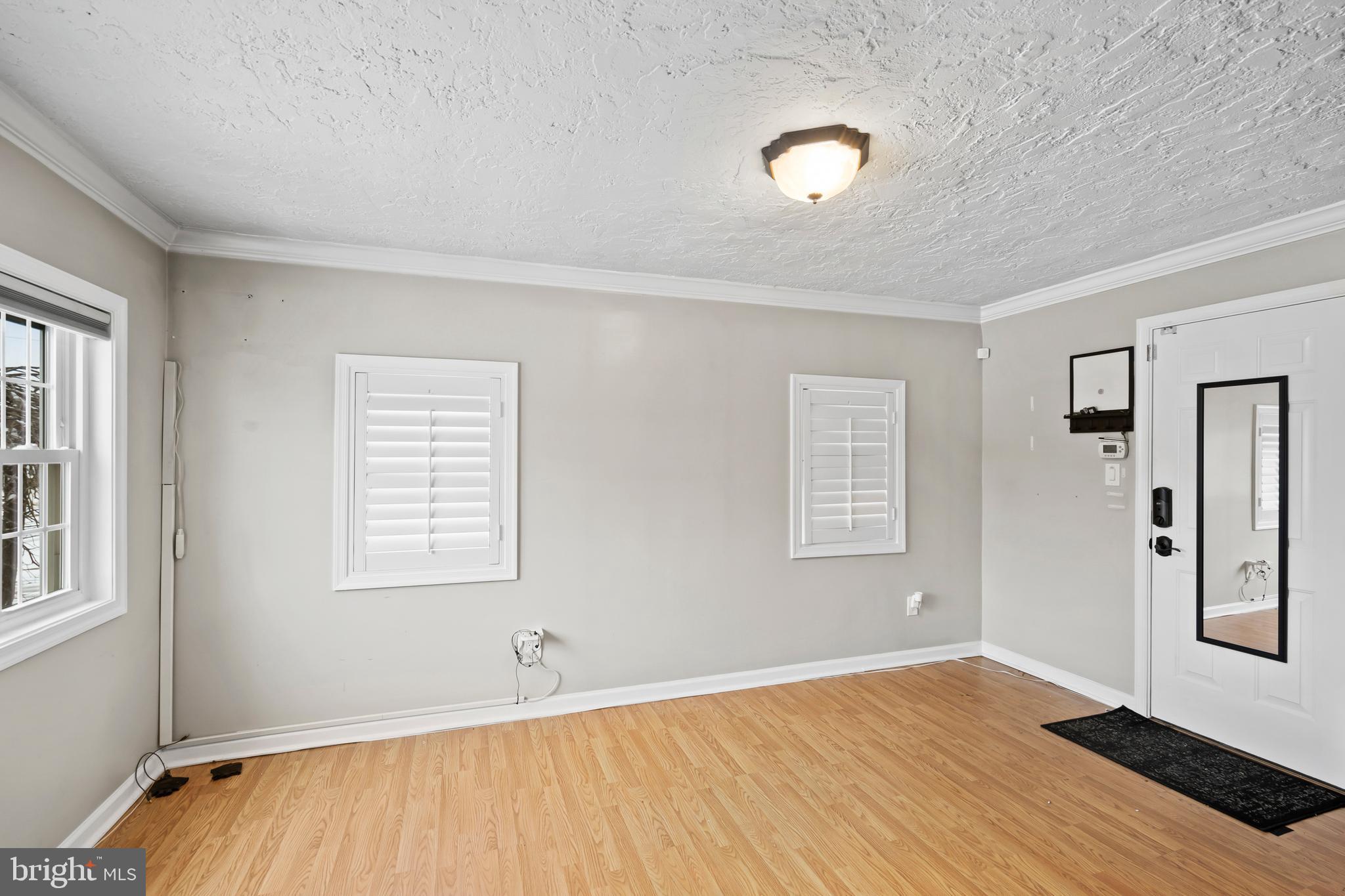 1028 Foss Avenue Drexel Hill, PA 19026 - Photo 8 of 48 a view of an empty room with wooden floor and a window