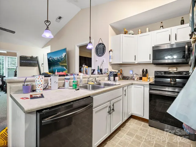 a kitchen with a sink a stove and a microwave