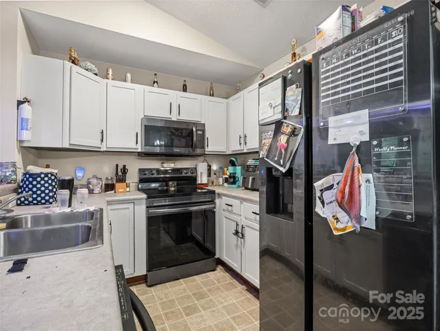 a kitchen with stainless steel appliances granite countertop a stove and a sink