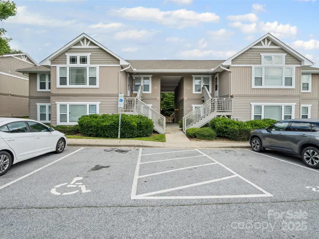 a car parked in front of a white house