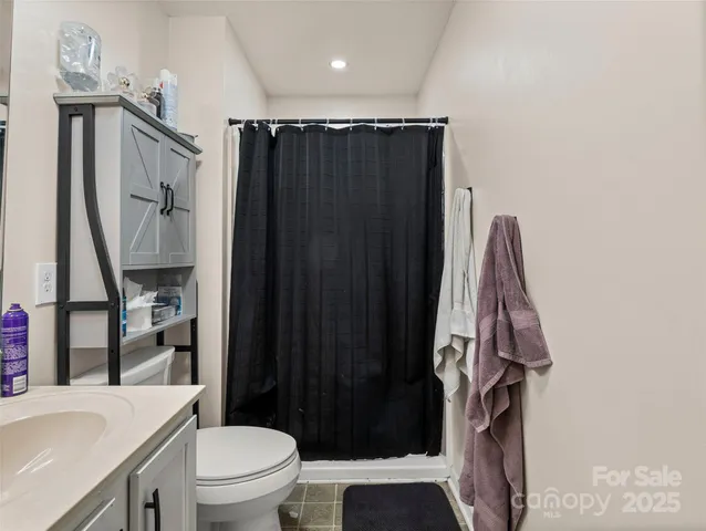 a bathroom with a toilet a sink and shower