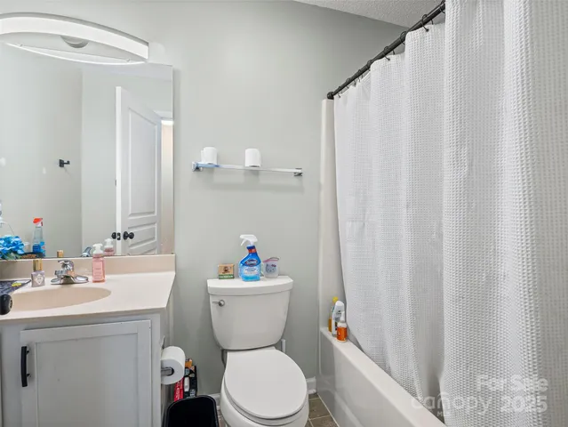 a white toilet sitting next to a bathroom sink