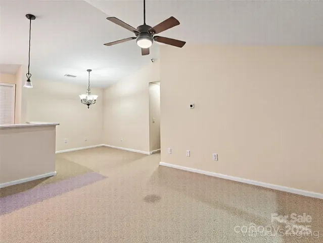 an empty room with a ceiling fan and a window