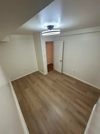an empty room with wooden floor