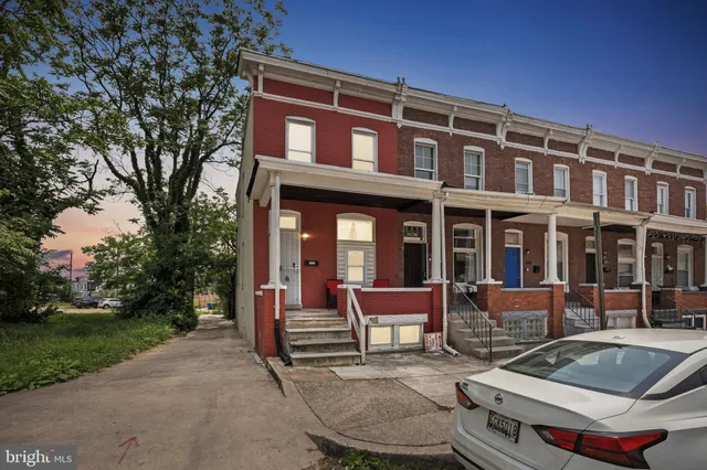 a view of a brick building with a bench in patio