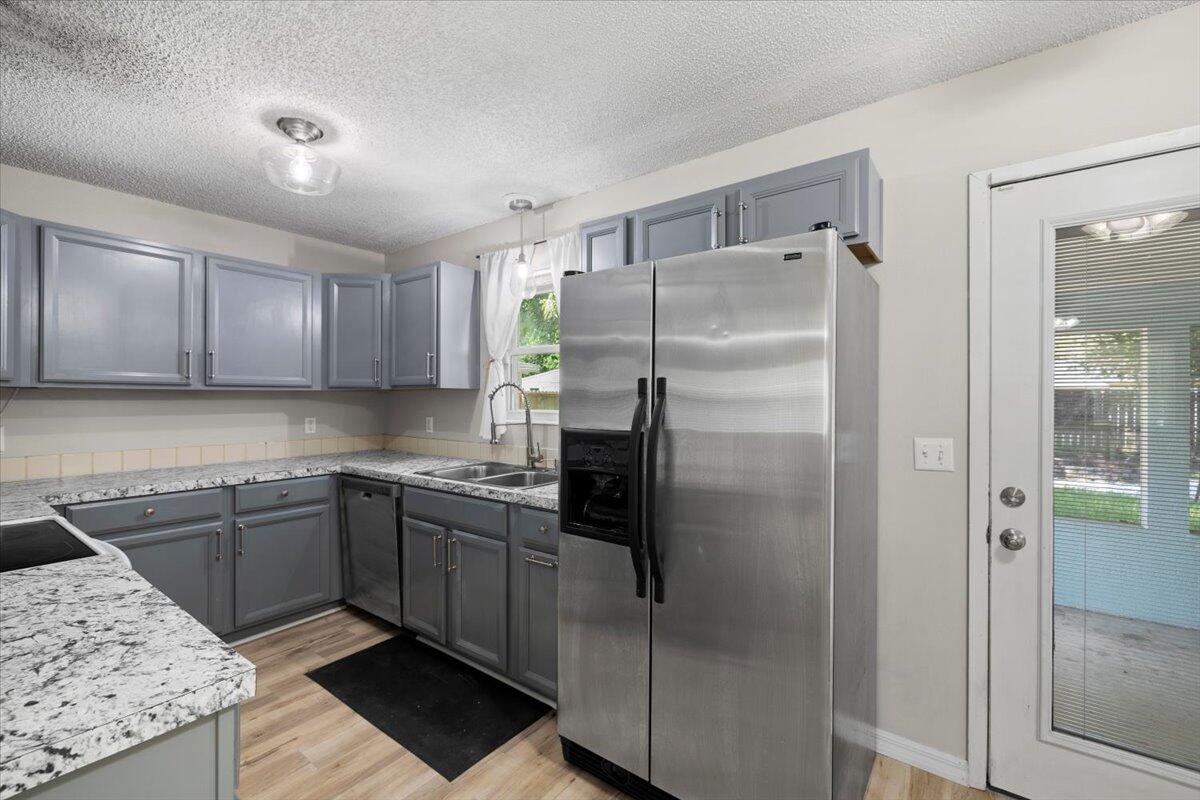 1008 Aspen Court Fort Walton Beach, FL 32547 - Photo 11 of 27 a kitchen with a sink a refrigerator and cabinets