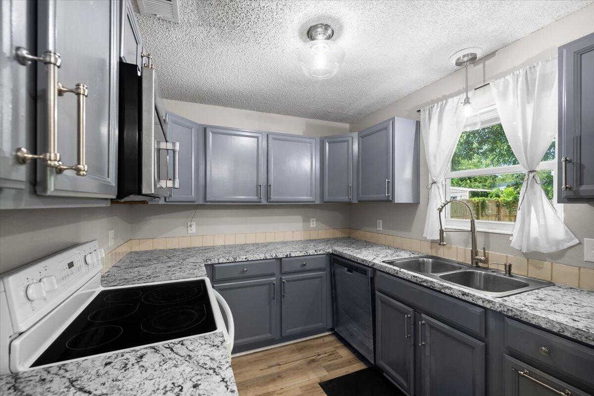 1008 Aspen Court Fort Walton Beach, FL 32547 - Photo 9 of 27 a kitchen with a sink stove and cabinets