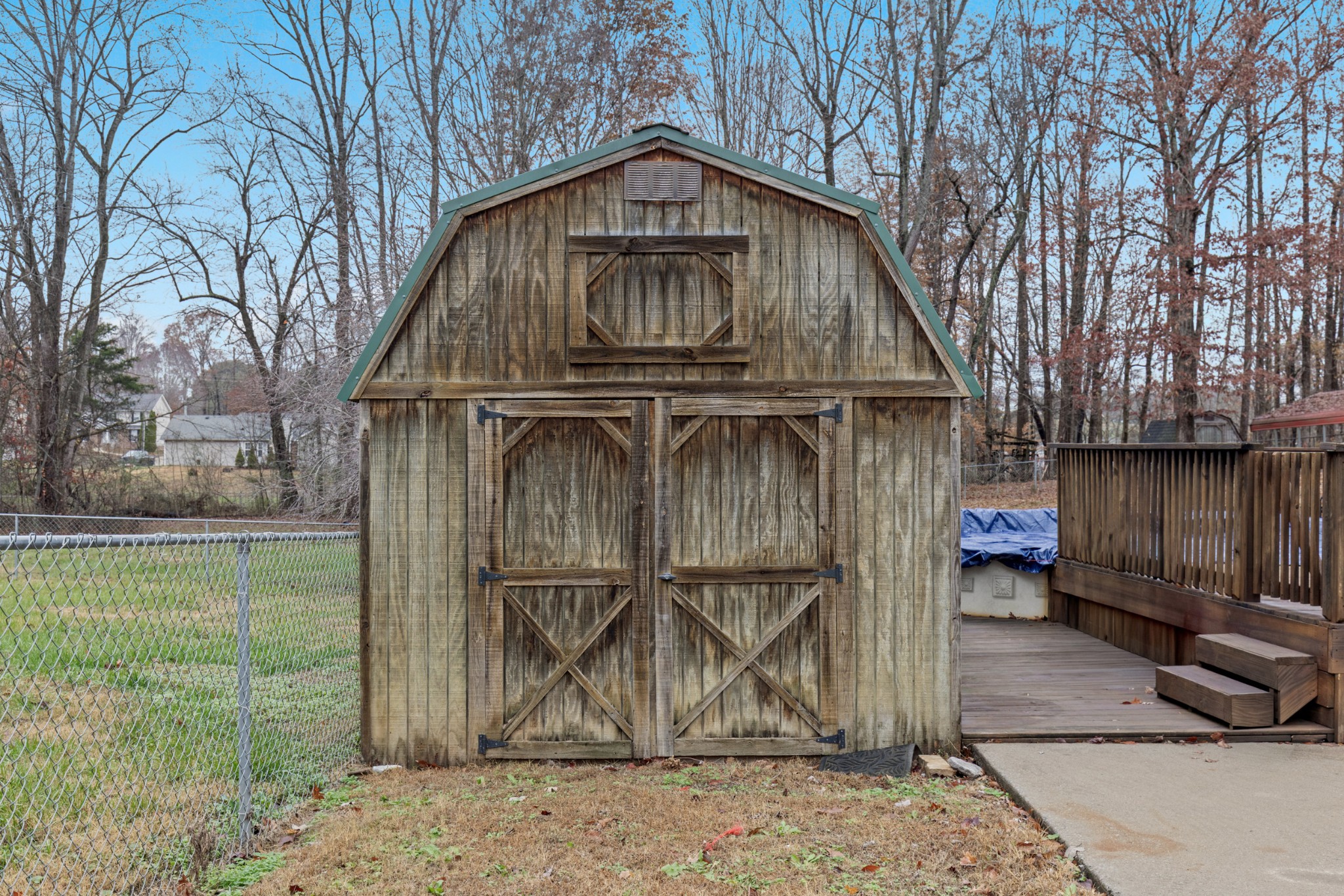 1069 Heatherwood Road Pleasant View, TN 37146 - Photo 14 of 45 a view of a small house with a wooden fence and a large tree