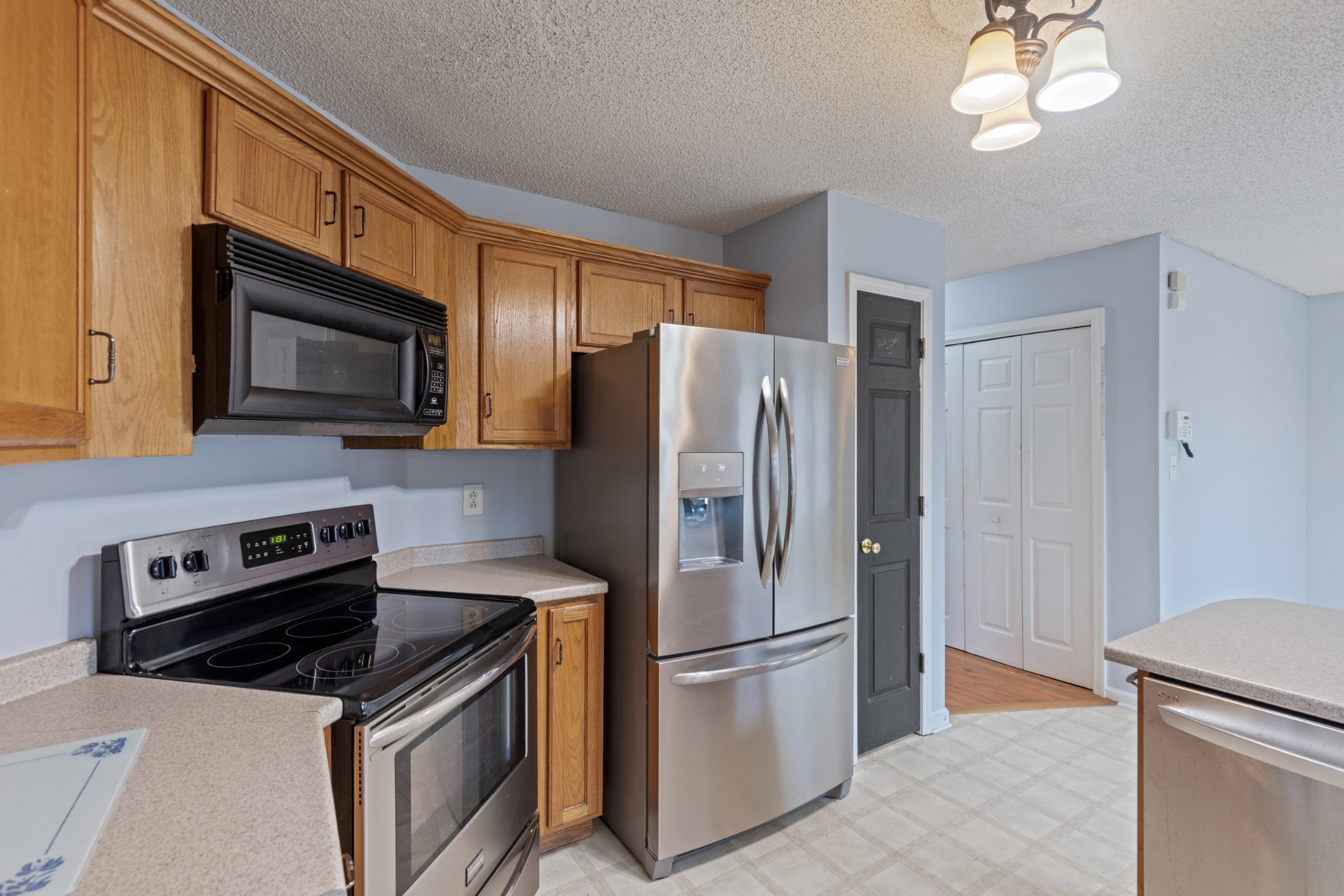 1069 Heatherwood Road Pleasant View, TN 37146 - Photo 18 of 45 a kitchen with stainless steel appliances a refrigerator a stove microwave and sink