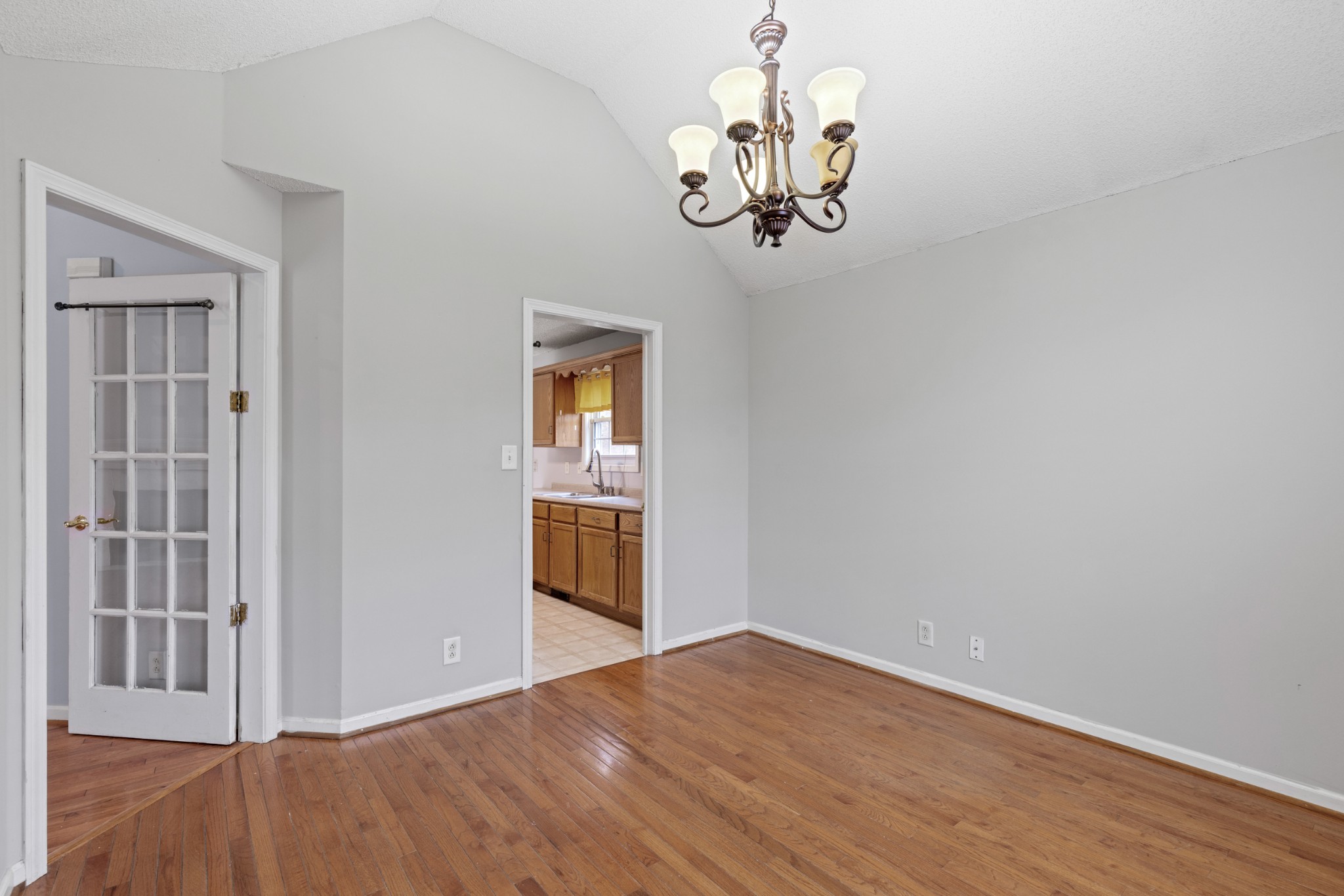 1069 Heatherwood Road Pleasant View, TN 37146 - Photo 20 of 45 an empty room with wooden floor chandelier and windows