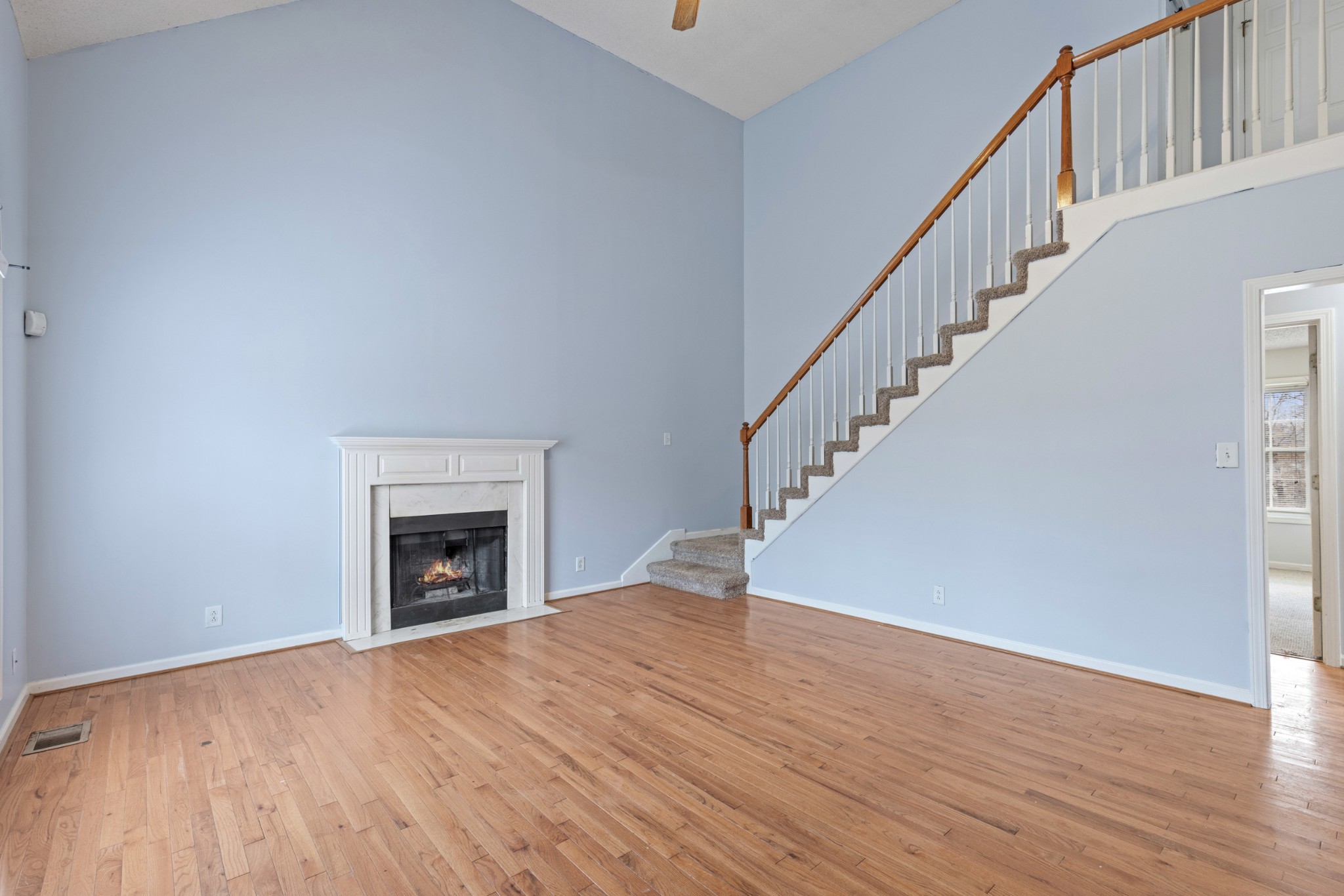 1069 Heatherwood Road Pleasant View, TN 37146 - Photo 3 of 45 a view of empty room with wooden floor and fireplace