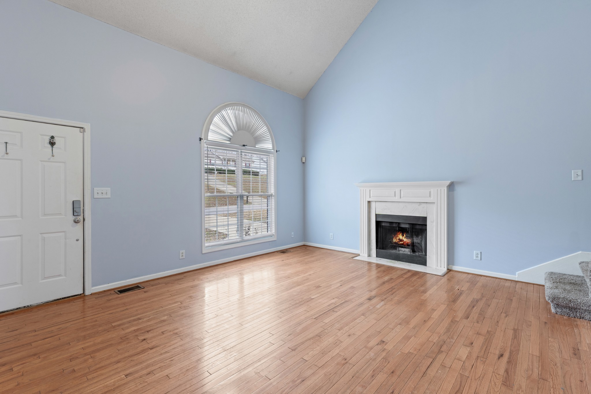 1069 Heatherwood Road Pleasant View, TN 37146 - Photo 4 of 45 a view of empty room with wooden floor and fireplace
