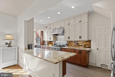 a kitchen with a stove and cabinets