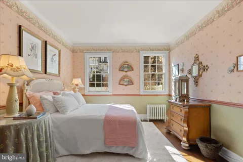 a view of entryway bedroom and hall with wooden floor