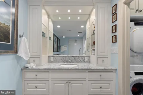 a view of a patio with a table and chairs and wooden fence