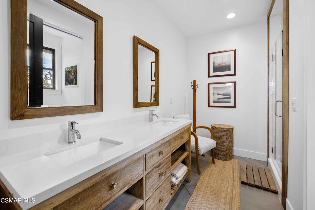 4637 Adam Road Simi Valley, CA 93063 - Photo 35 of 70 a bathroom with double vanity sink a mirror and a toilet