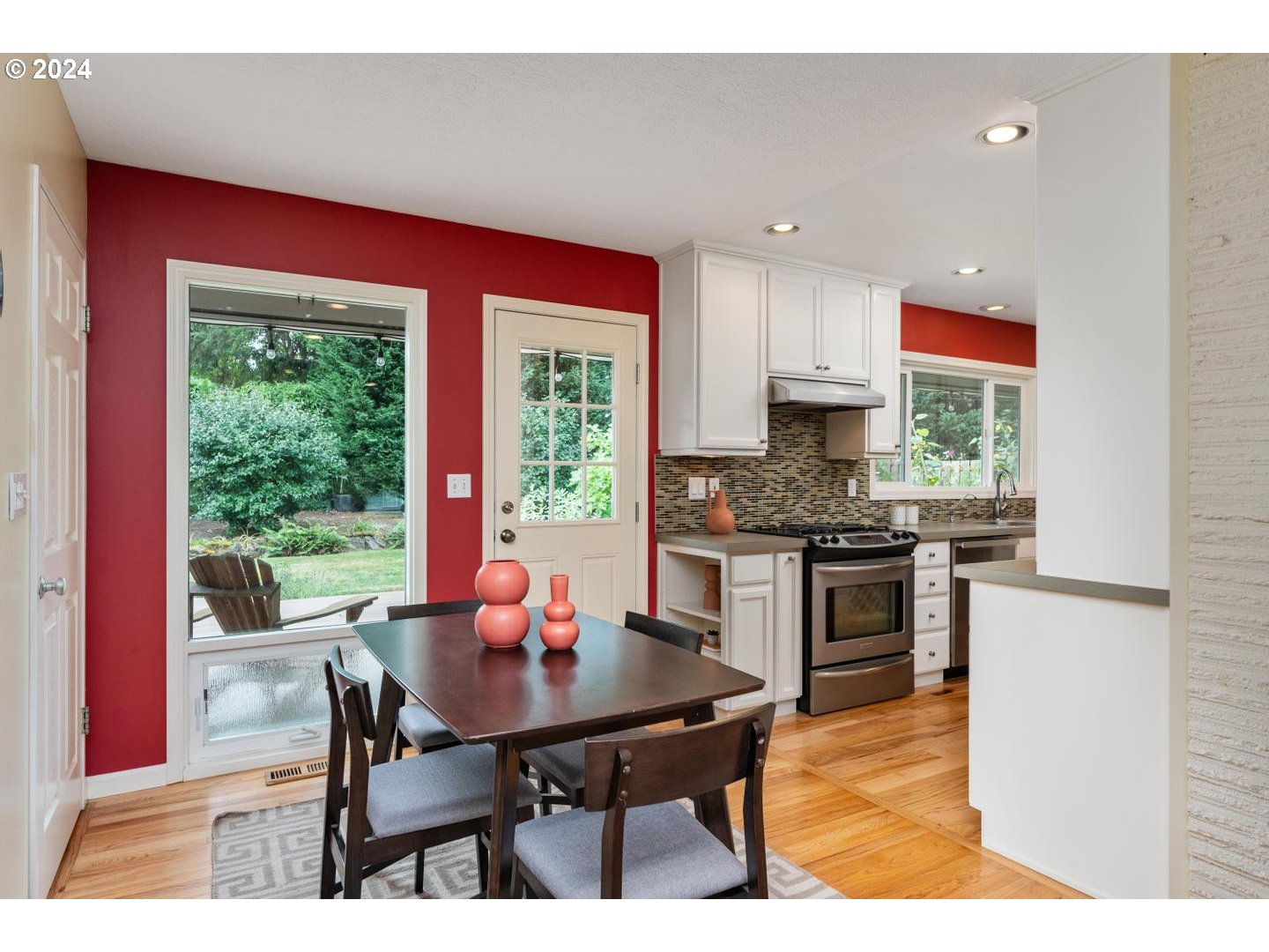 12250 Southwest Tremont Street Portland, OR 97225 - Photo 14 of 38 a kitchen with stainless steel appliances kitchen island granite countertop a dining table chairs and sink