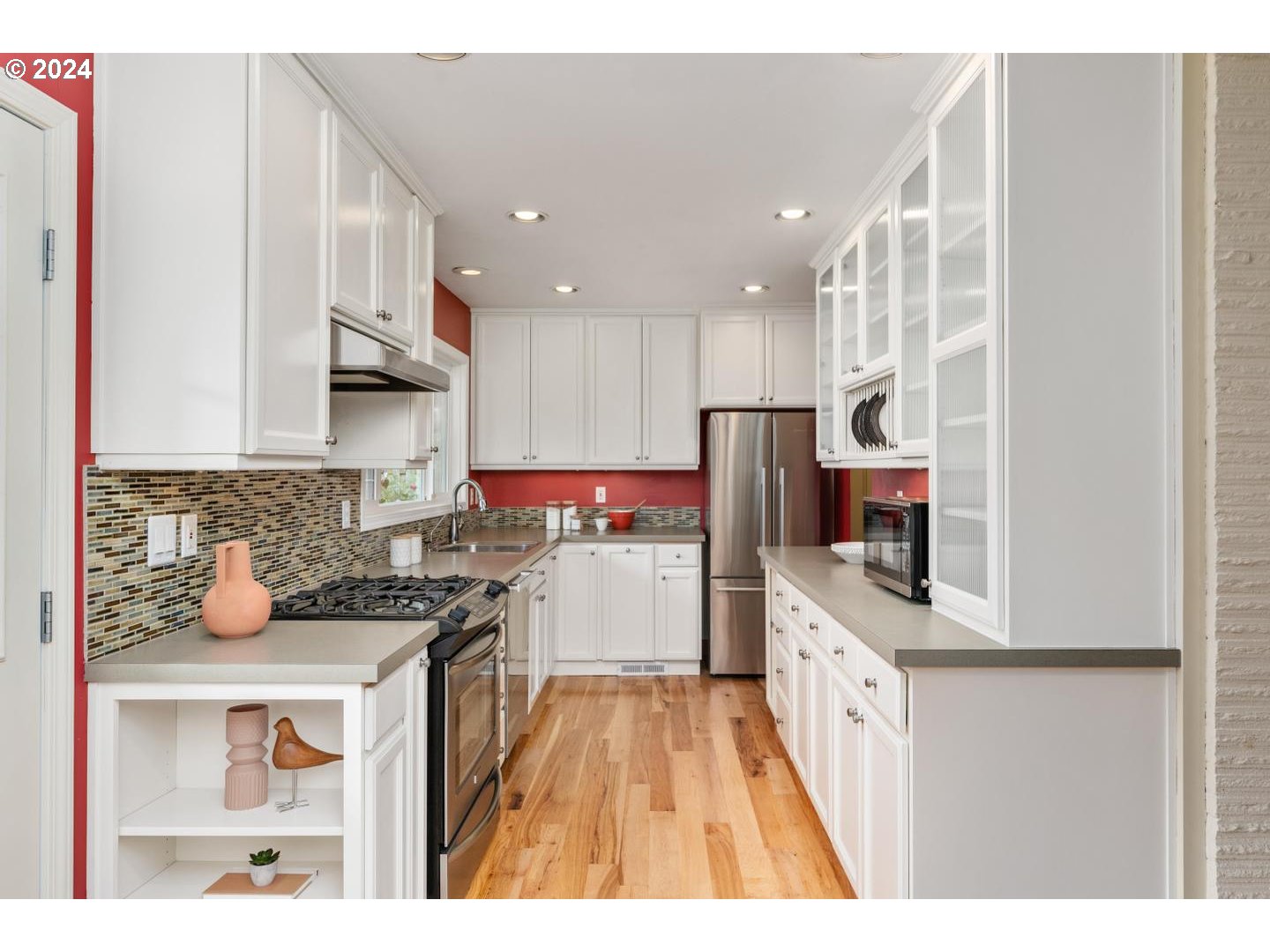 12250 Southwest Tremont Street Portland, OR 97225 - Photo 16 of 38 a kitchen with a sink a stove top oven a counter space and cabinets