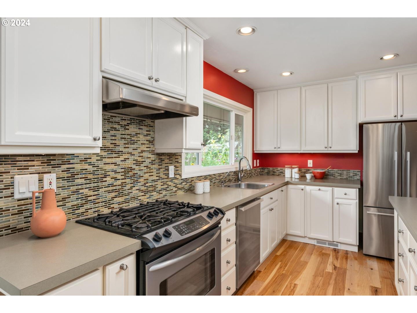 12250 Southwest Tremont Street Portland, OR 97225 - Photo 17 of 38 a kitchen with stainless steel appliances granite countertop a stove a sink dishwasher and a refrigerator