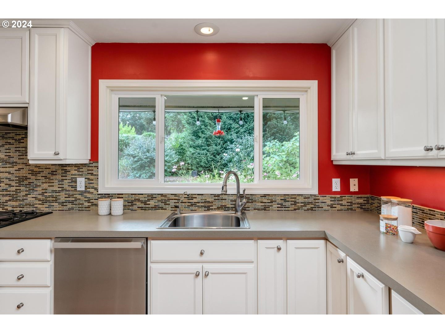 12250 Southwest Tremont Street Portland, OR 97225 - Photo 18 of 38 a kitchen with a sink a window and cabinets
