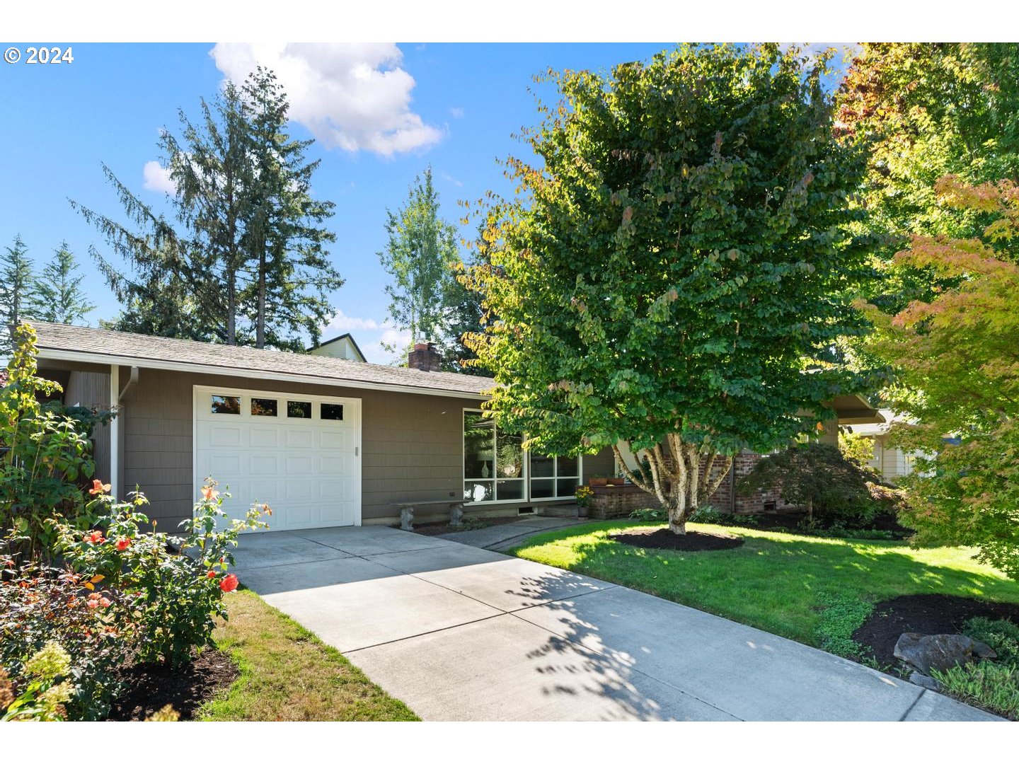 12250 Southwest Tremont Street Portland, OR 97225 - Photo 2 of 38 a front view of a house with a yard and a garage