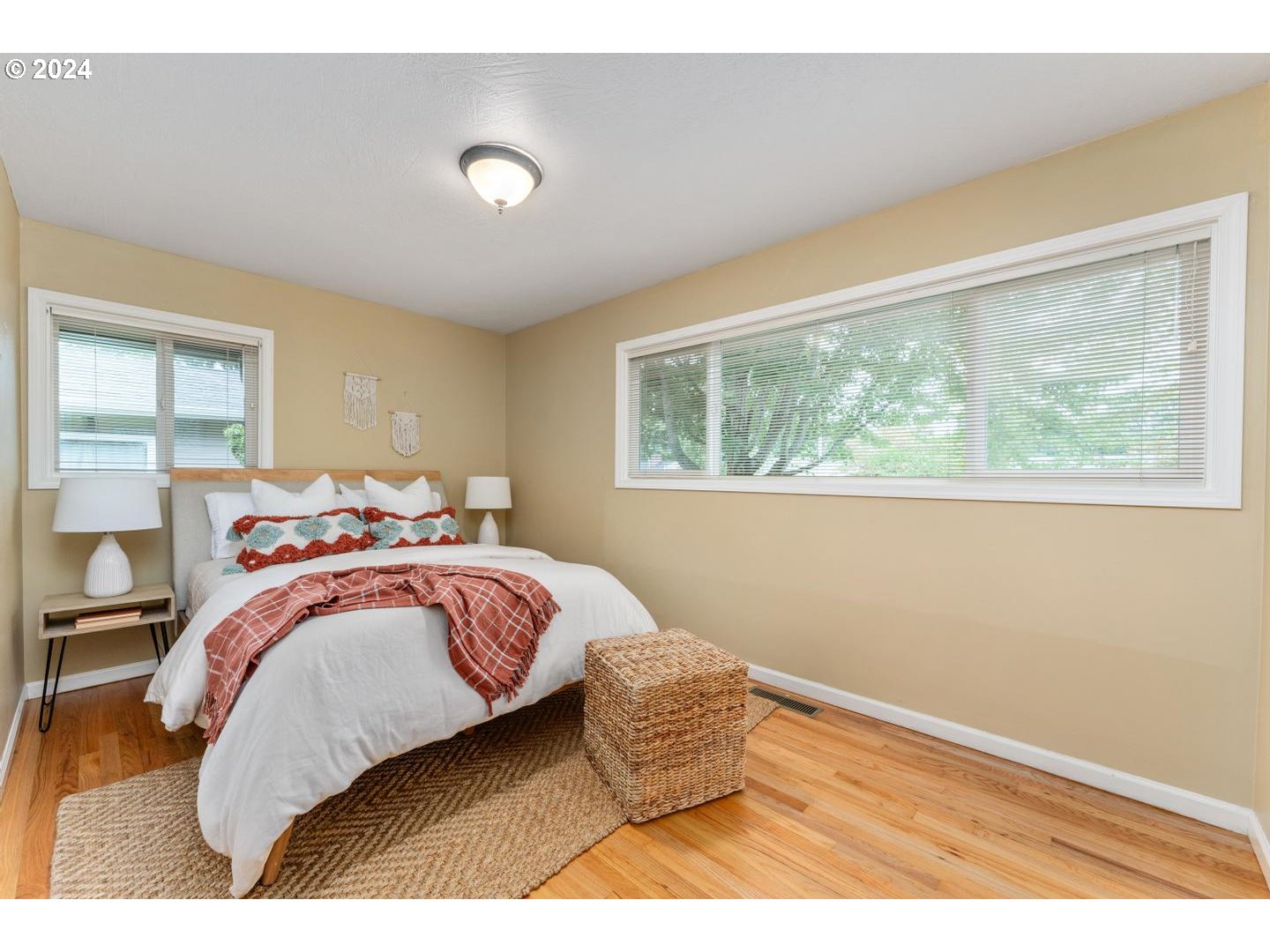 12250 Southwest Tremont Street Portland, OR 97225 - Photo 21 of 38 a bedroom with a bed and wooden floor