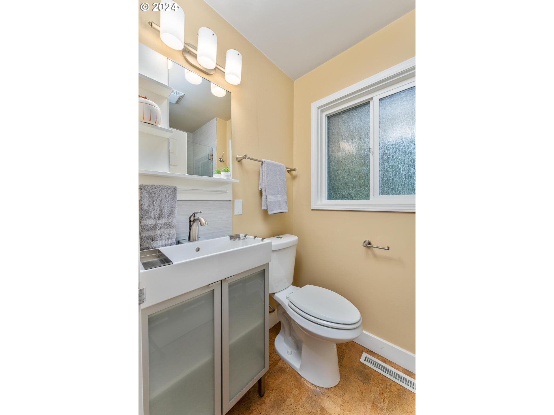 12250 Southwest Tremont Street Portland, OR 97225 - Photo 23 of 38 a bathroom with a toilet sink vanity and mirror