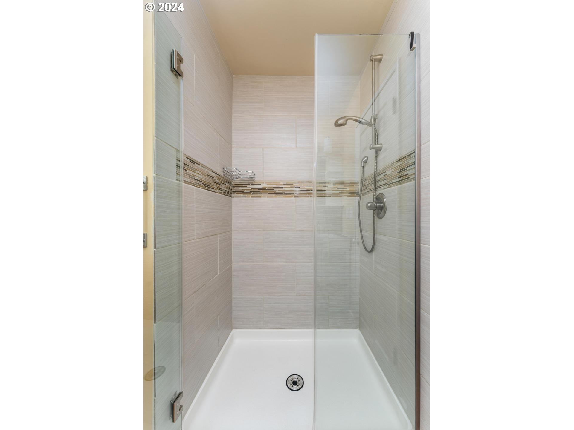 12250 Southwest Tremont Street Portland, OR 97225 - Photo 24 of 38 a bathroom with a glass shower door
