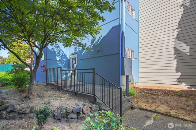 a view of a house with a small yard and wooden fence