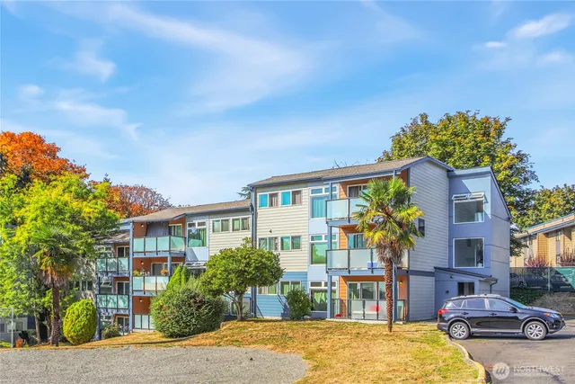 a front view of a house with a yard and seating space
