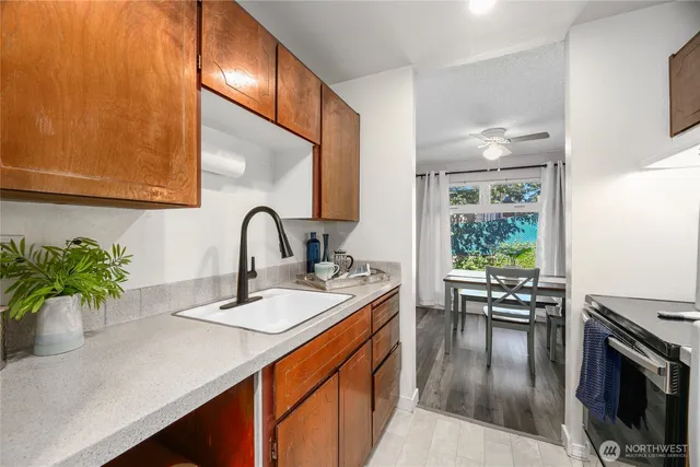 a kitchen with a sink a counter and cabinets