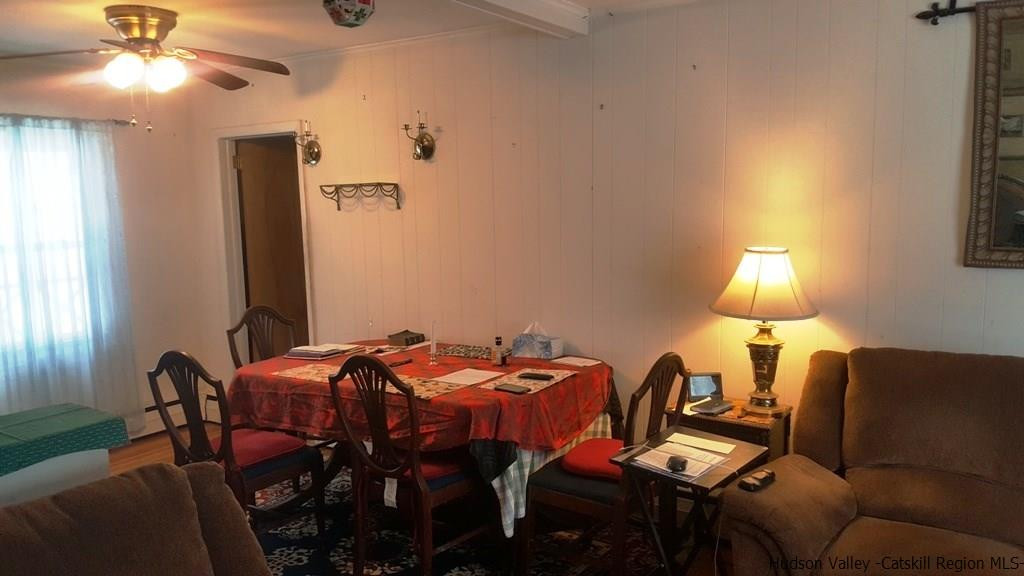 58 Schoonmaker Lane Stone Ridge, NY 12484 - Photo 3 of 10 a view of a dining room with furniture and chandelier