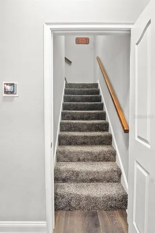 a living room with furniture a flat screen tv and a large window