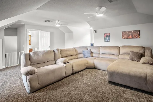 a living room with furniture and a floor to ceiling window