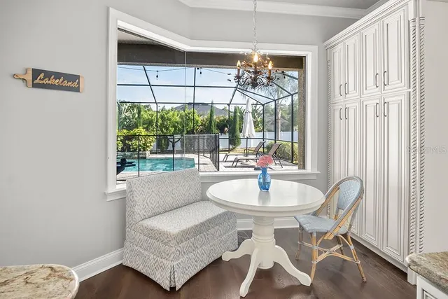 a dining room with furniture a chandelier and window