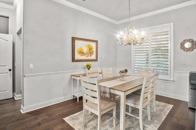 a view of a dining room with furniture and chandelier